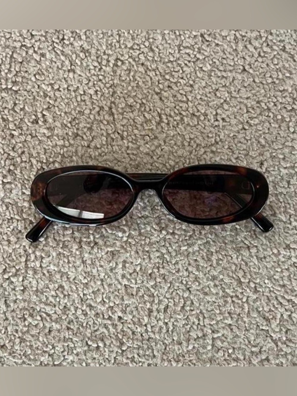 Brown tortoiseshell sunglasses with dark lenses